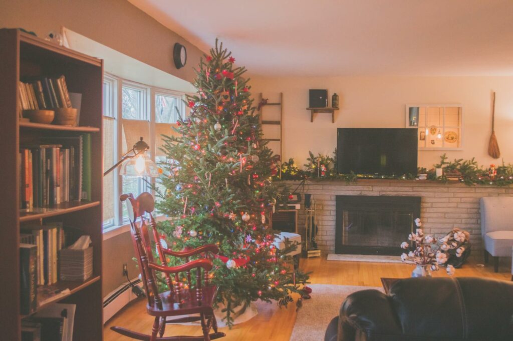 Warm and inviting living room with a Christmas tree, fireplace, and holiday decor, perfect for the winter season.